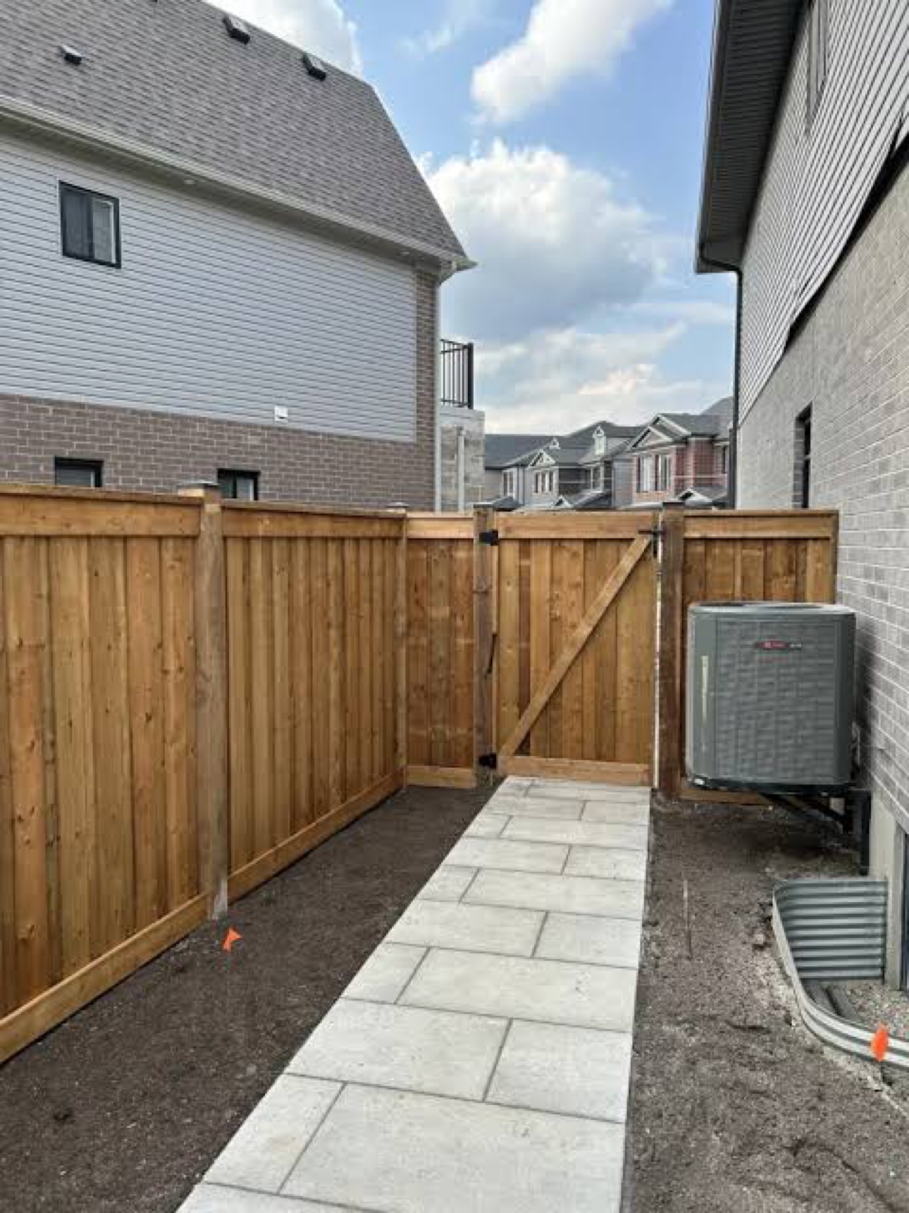 Side-yard fence and gate with paver walkway
